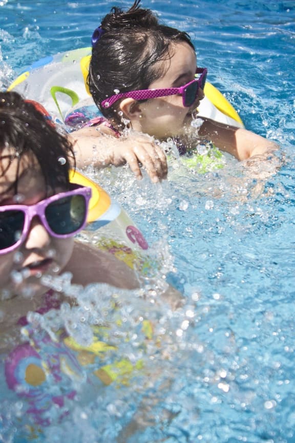 two girls swimming in a swimming pool