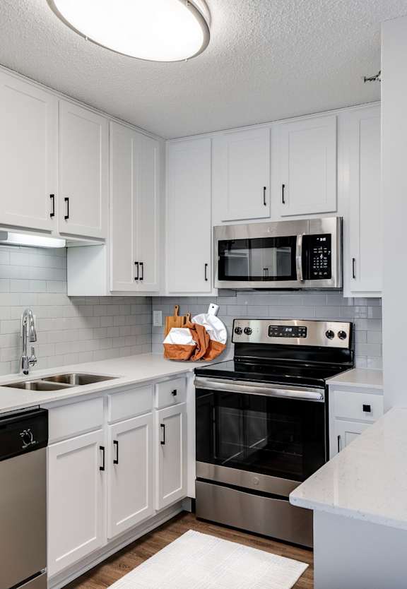 Fully Equipped Kitchen with white cabinets