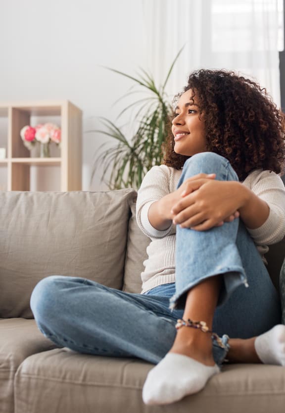 a woman sitting on a couch with her legs crossed
