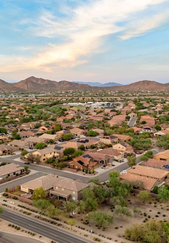 A suburban neighborhood with houses and a road.