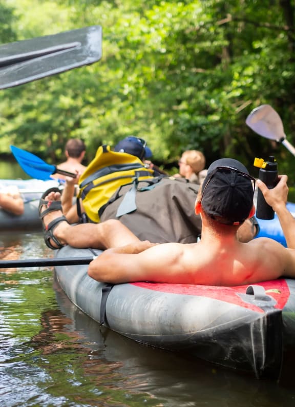 Friends Kayaking on River Together