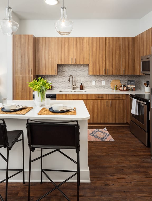 a kitchen with stainless steel appliances and a table with chairs