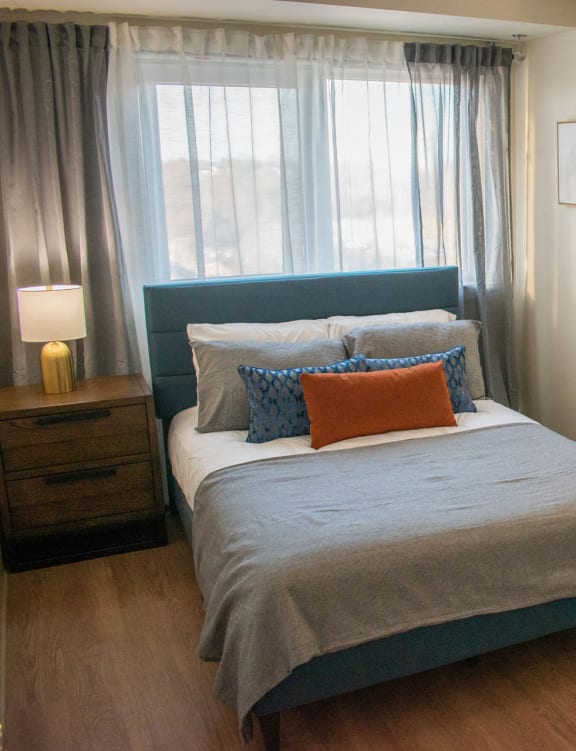 a bedroom with a bed and a chair