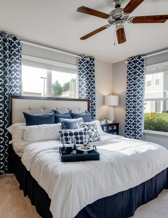 Bedroom With Multiple Windows That Let In Lots Of Natural Light