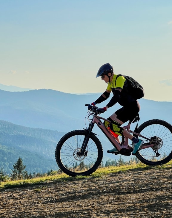 Man Wearing Helmet Riding Mountain Bike