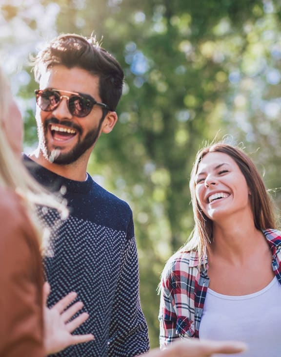 a group of people laughing and talking to each other