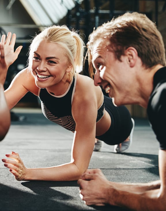 a group of people in a gym giving each other a high five