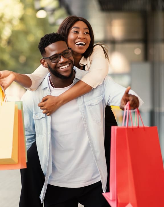 Man and Woman Holding Shopping Bags Smiling