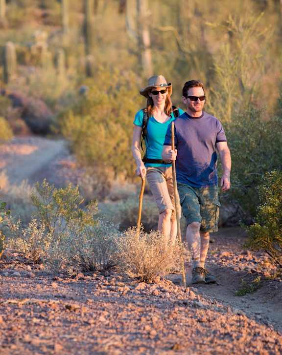 Man and Woman Walking in Desert