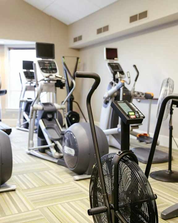 a gym with various exercise equipment in a room
