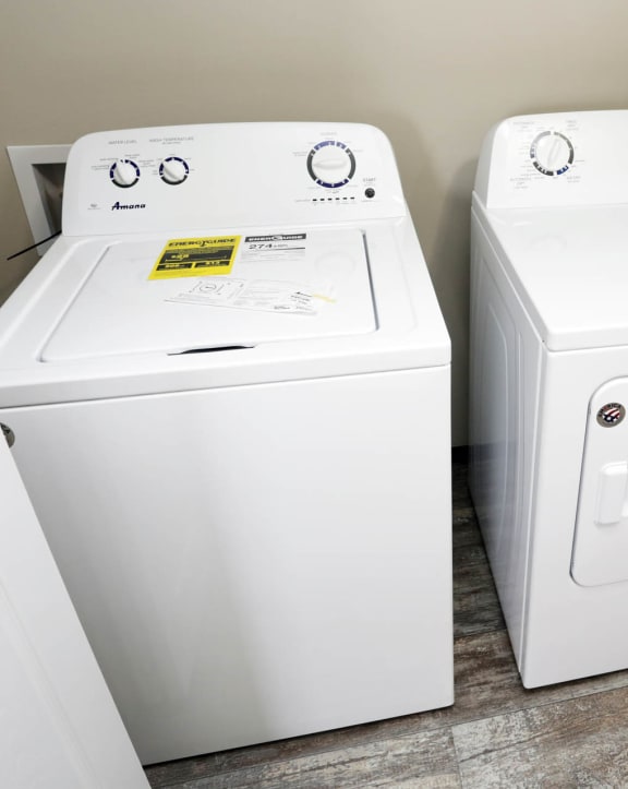 a washer and dryer sit next to each other in a laundry room
