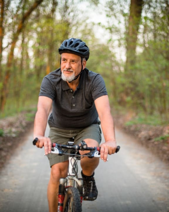 Mad Riding Bike on Path Through Woods