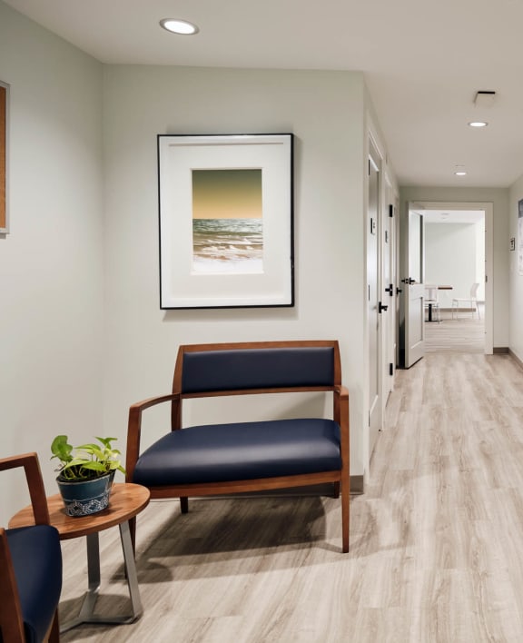 a corridor with a chair and a table