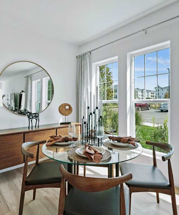 A dining room with a round table and chairs. at Altis Twin Lakes Apartments, Kissimmee, FL 34744