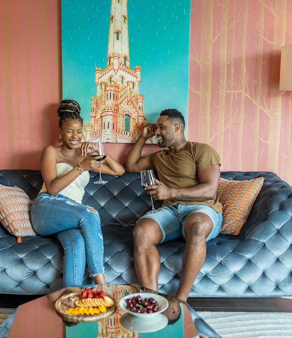 a aerial view of the beach with people standing on the sand and the water