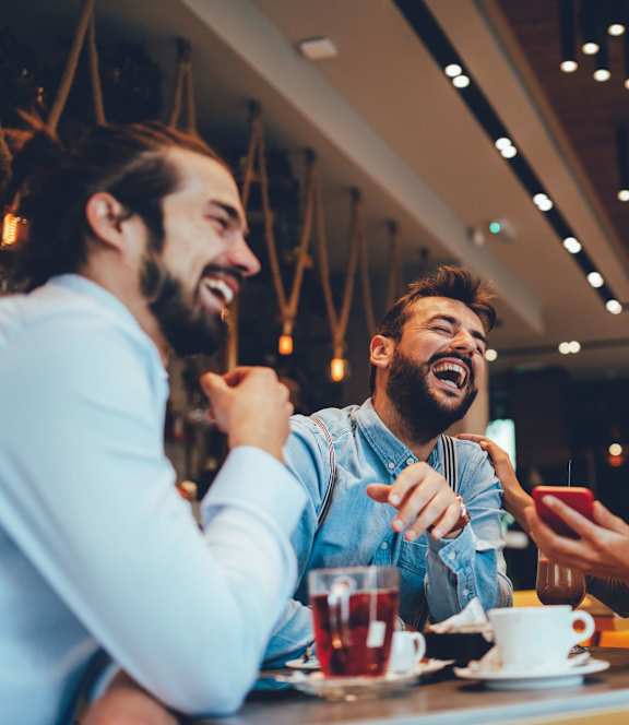 a group of people sitting at a table in a restaurant at The Villa at River Pointe, Maumelle, AR 72213