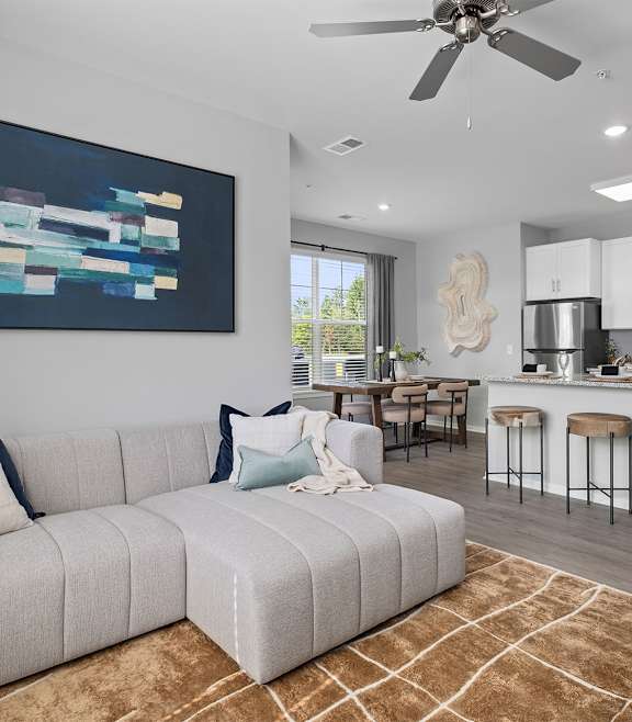 a living room with a couch and a ceiling fan
