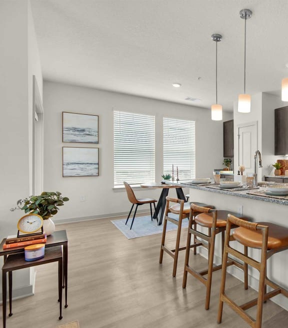 spacious kitchen with stainless steel appliances and a large island with bar stools at The Enclave at Deer Moss Creek, Niceville, 32578