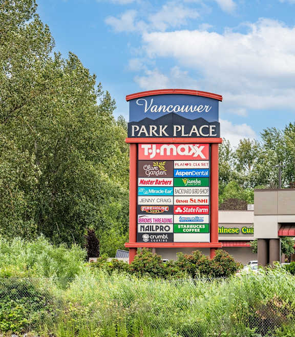 A sign for Vancouver Park Place with a T-Mobile store and an Aspen Dental office.at Vancouver Mall Apartments, Vancouver, WA