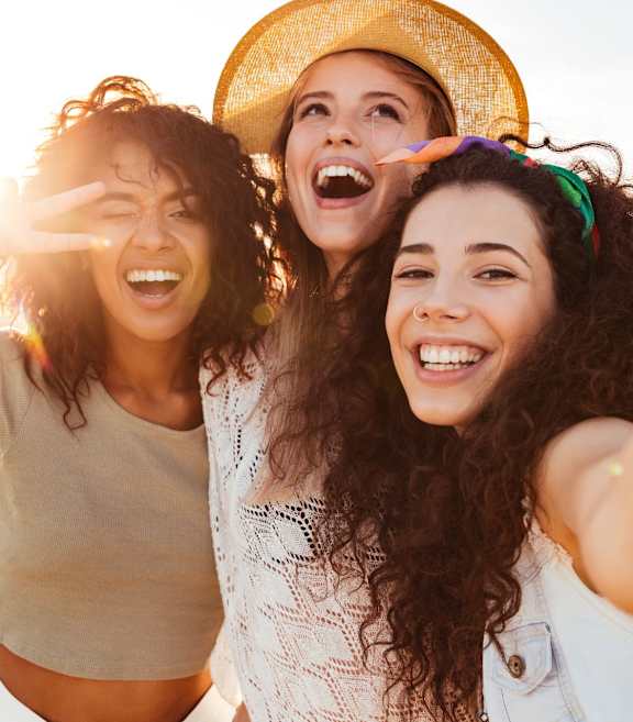 a group of women are laughing on the beach at Esplanade District Apartments, Little Rock