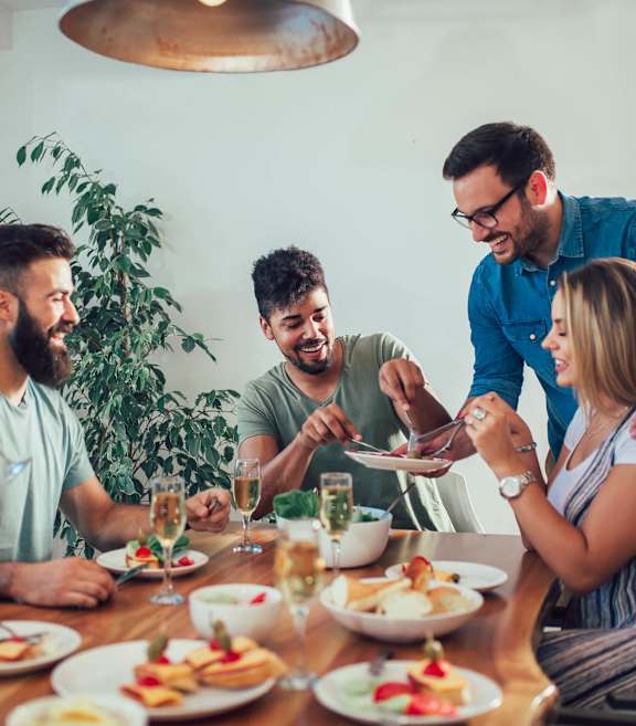 a group of people sitting around a table eating food