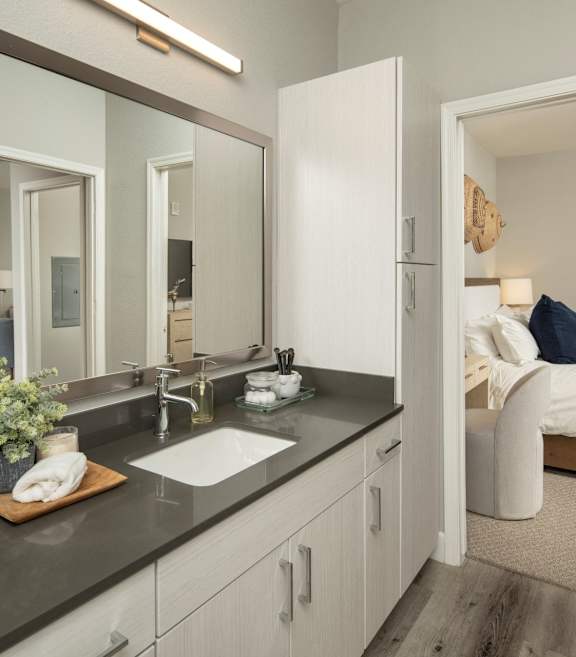 Spire Deer Valley Apartments in Phoenix, Arizona Model Bathroom and View into Bedroom