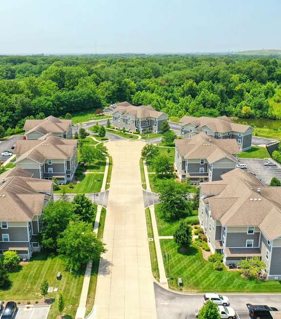 A bird's eye view of a residential area with houses and cars.