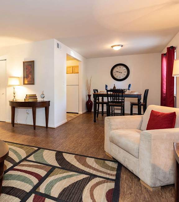 A living room with a couch, chair, and coffee table.