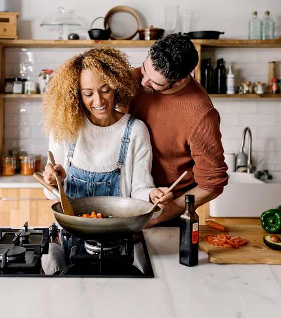 Man and Woman Cooking at Home Together