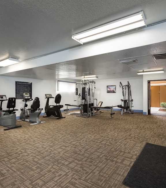 A gym with treadmills, weights, and exercise equipment at Bixby Knolls, Long Beach