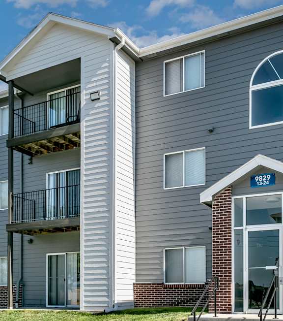 A grey apartment building with the number 8222 on the front door.