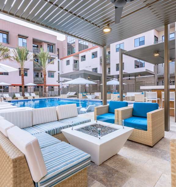 The Benedictine Apartments in Tucson, Arizona Poolside Patio with Seating and Fire Pit