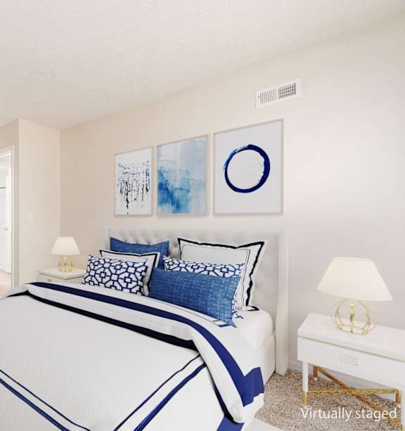 A bedroom with a large bed and a chair.