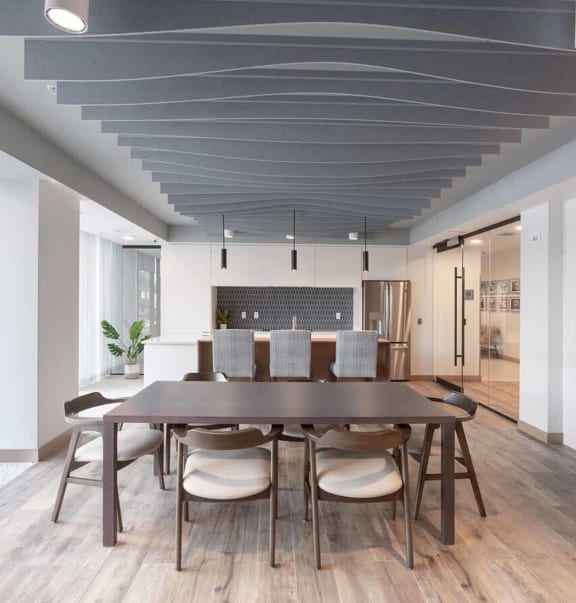 a dining room with a wooden table and chairs