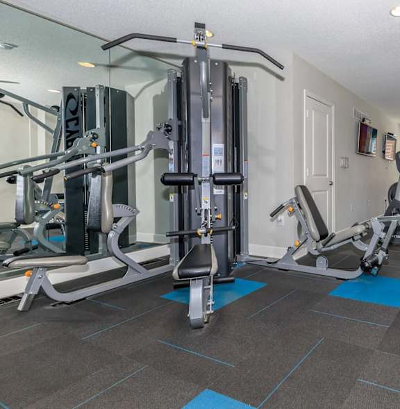 A gym with a variety of equipment including a leg press machine.