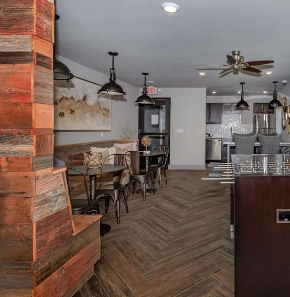 A room with a wooden floor and a large painting on the wall.