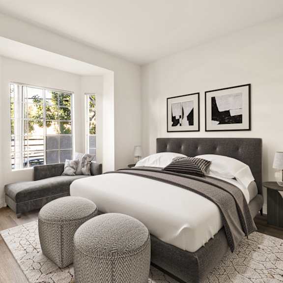 a bedroom with white walls and a large bed with a black and white checkered blanket