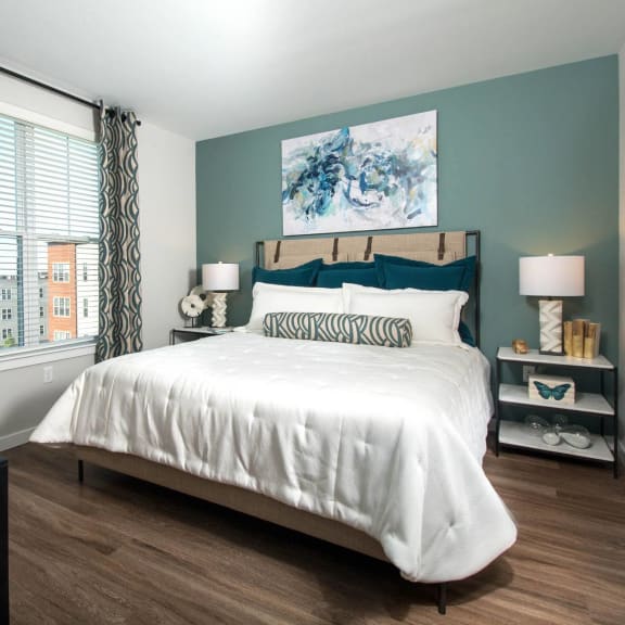 a bedroom with a bed and a large window