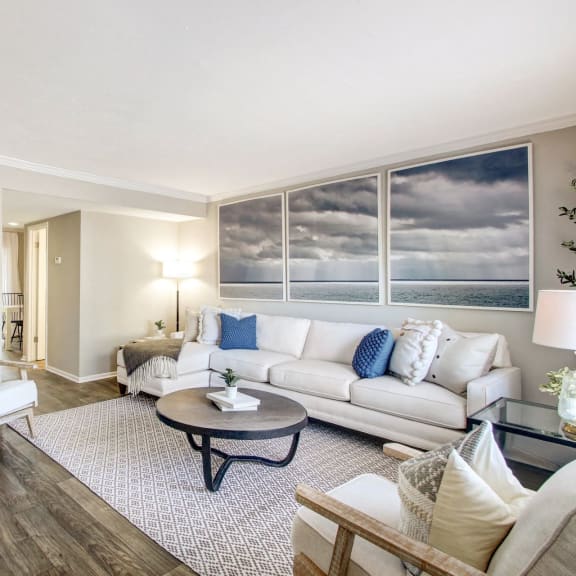 Beautiful living room with white and blue design at The Fountains at Deerwood, Florida 32256