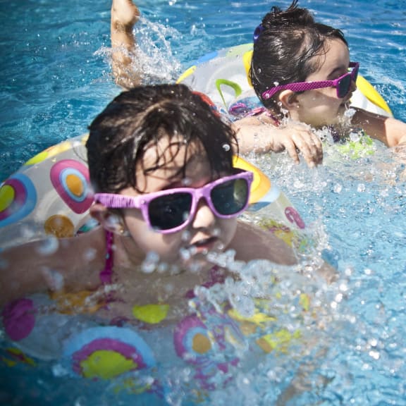 two girls swimming in a swimming pool