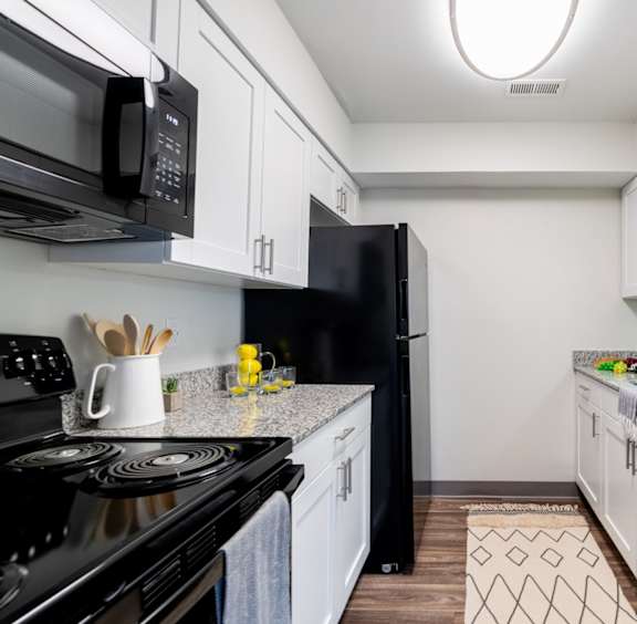Modern Kitchen with White Cabinetry and Efficient Appliances at Governor Square in Carmel, IN