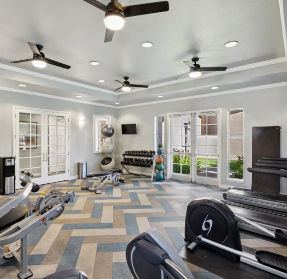 fitness center with cardio equipment and free weights at Bridgeport Ranch apartments