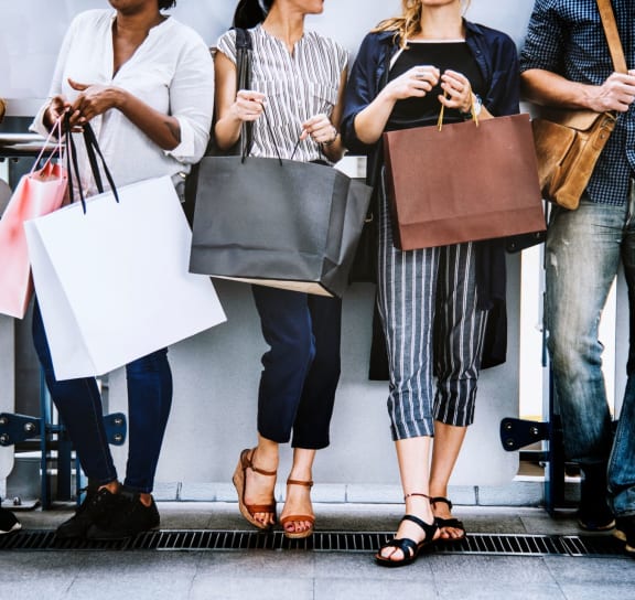 a group of people holding shopping bags