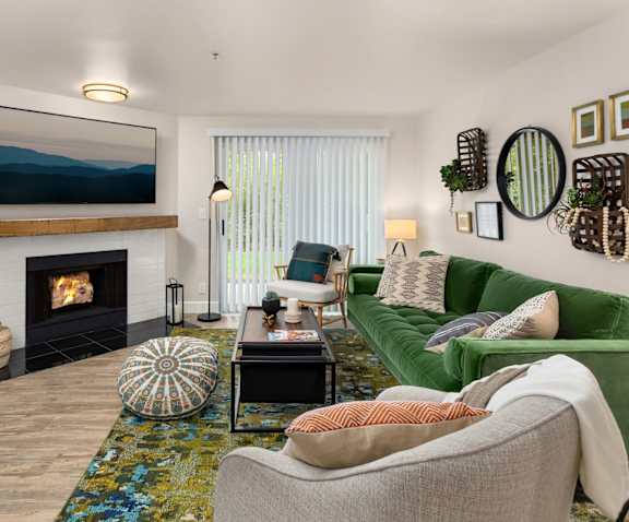 A living room with a fireplace and a painting on the wall.