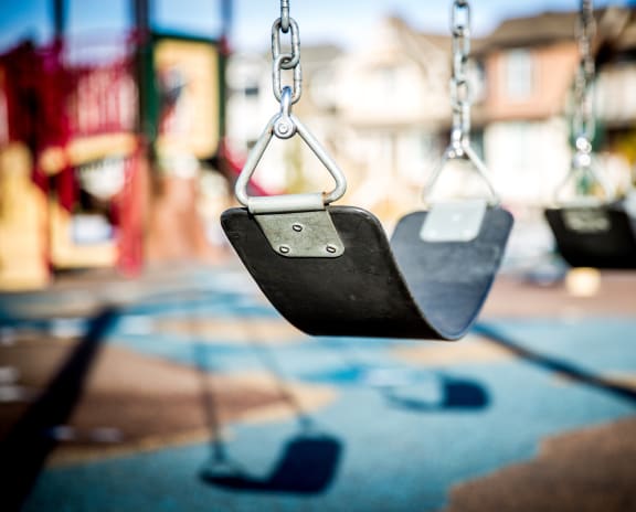 a picture of empty swings at a park