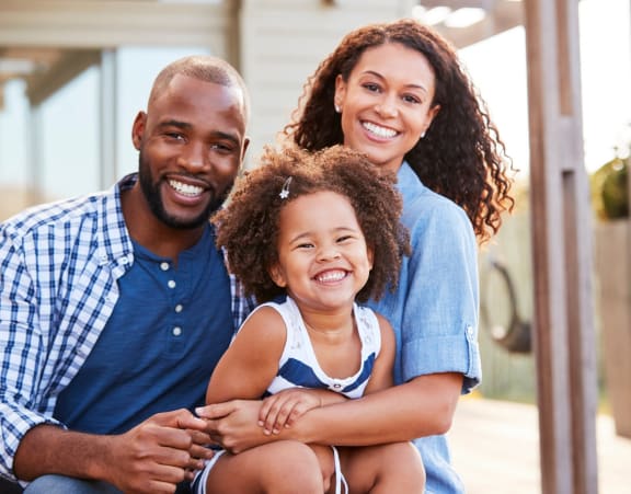 a family posing for a picture with their child