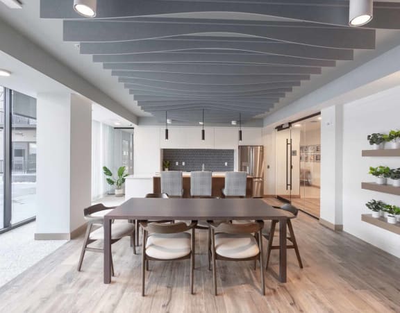 a dining room with a wooden table and chairs