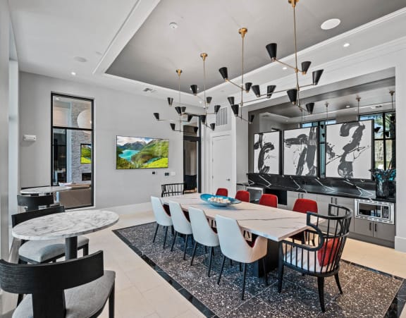 A modern dining room with a large table and chairs. at Altis Twin Lakes Apartments, Kissimmee, FL 34744