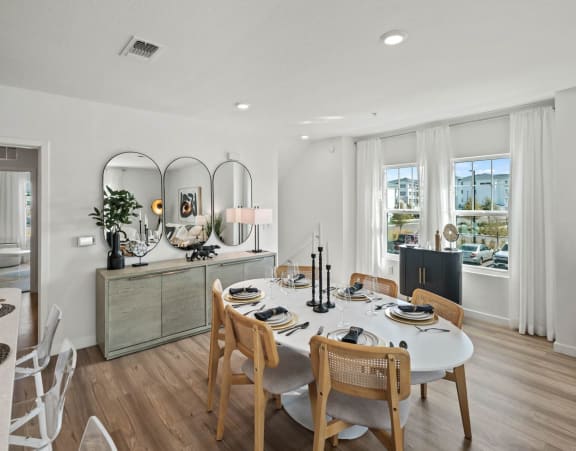 A dining room with a table set for a meal. at Altis Twin Lakes Apartments, Kissimmee, FL 34744