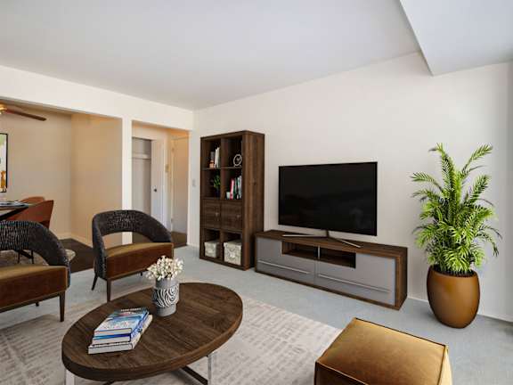 A living room with a brown coffee table and a brown ottoman.